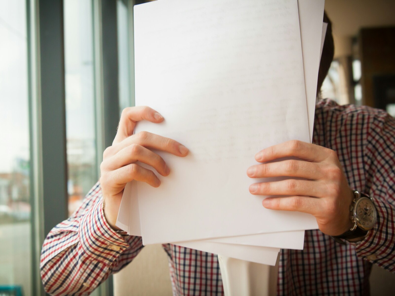 person holding white printer paper